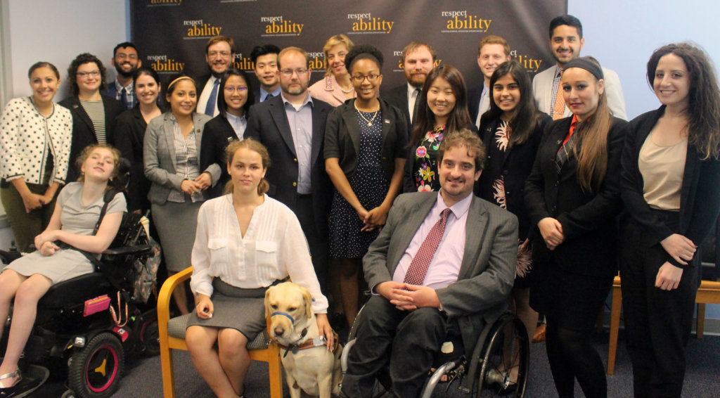 All of the fellows and staff standing in a large group against the wall with the RespectAbility logo all over it