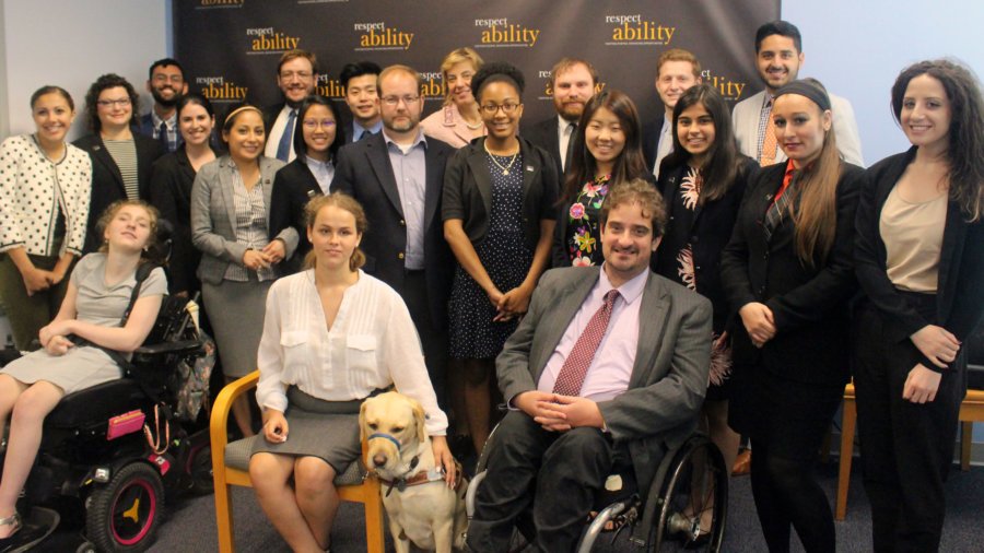 All of the fellows and staff standing in a large group against the wall with the RespectAbility logo all over it