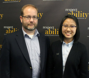 Judith Lao standing in front of the RespectAbility wall with Kevin Webb