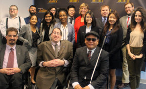 All of the fellows and staff standing in a large group against the wall with the RespectAbility logo all over it