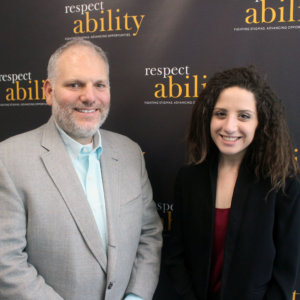 William Daroff standing in front of the RespectAbility wall with Elle Issacharoff
