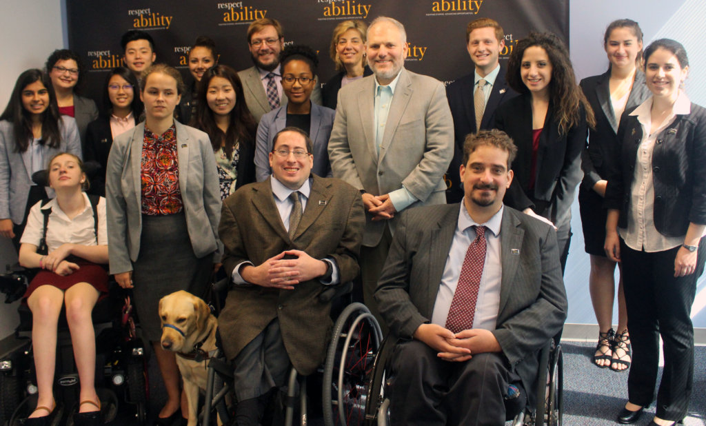 All of the fellows and staff standing in a large group against the wall with the RespectAbility logo all over it