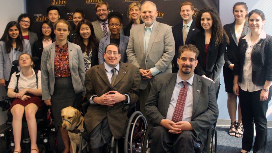 All of the fellows and staff standing in a large group against the wall with the RespectAbility logo all over it