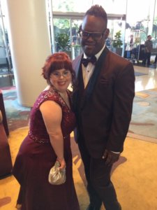 Rachel Osterbach and John Tucker posing in a gown and a tux