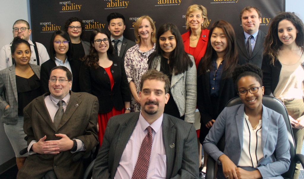 All of the fellows and staff standing in a large group against the wall with the RespectAbility logo all over it