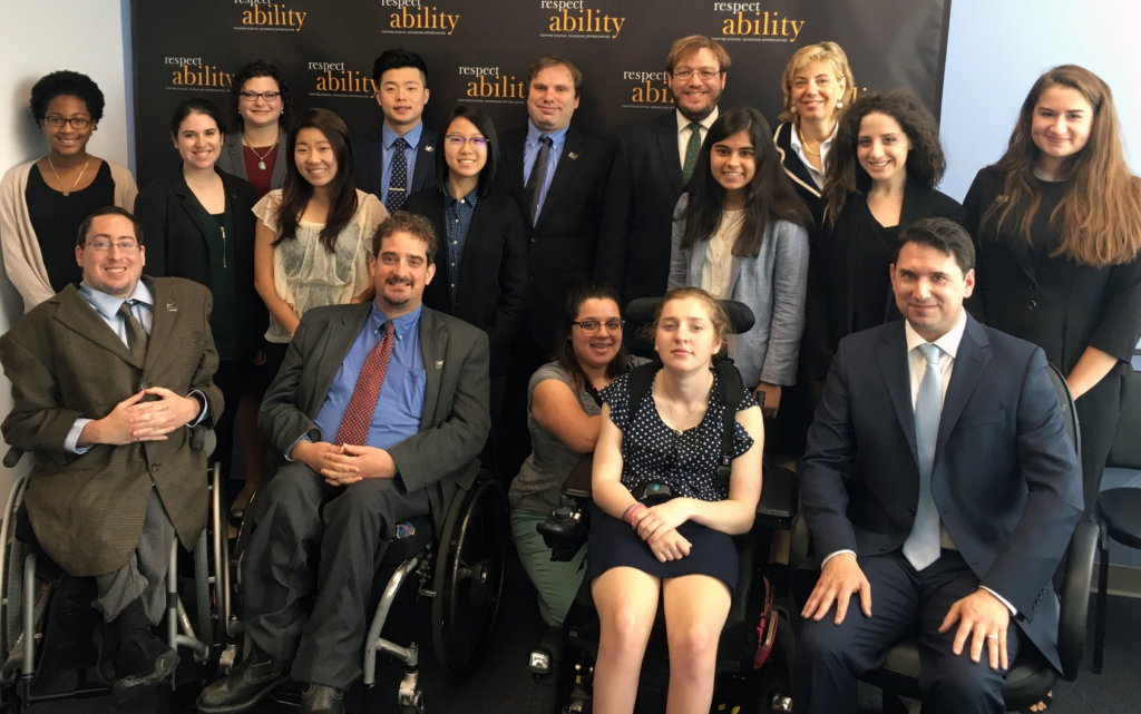 All of the fellows and staff standing in a large group against the wall with the RespectAbility logo all over it