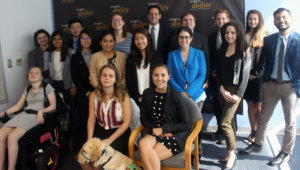 All of the fellows and staff standing in a large group against the wall with the RespectAbility logo all over it