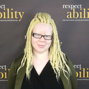 RespectAbility fellow Katie Townes smiling in front of the RespectAbility banner