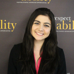 Respectability fellow Brooke Castagna smiling in front of the Respectability banner