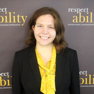 Respectability fellow Theresa Maher smiling in front of the Respectability banner