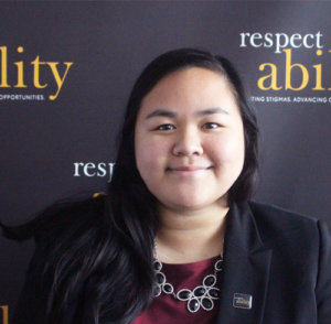 Respectability fellow Julie Lun smiling in front of the Respectability banner
