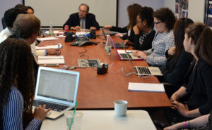 Jonathan D Salant speaking to RespectAbility Fellows seated around a large brown table