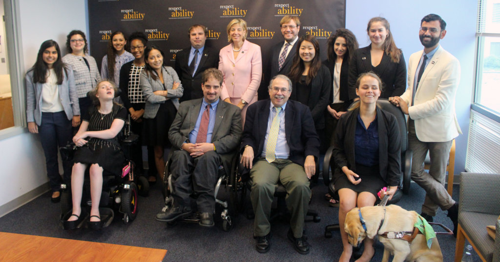 All of the fellows and staff standing in a large group against the wall with the RespectAbility logo all over it