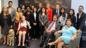 All of the fellows and staff standing in a large group against the wall with the RespectAbility logo all over it