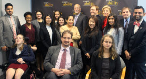 All of the fellows and staff standing in a large group against the wall with the RespectAbility logo all over it