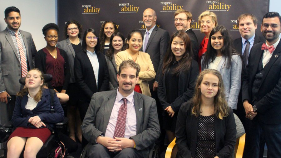 All of the fellows and staff standing in a large group against the wall with the RespectAbility logo all over it