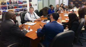 Rodney Hood speaking to RespectAbility Fellows seated around a large brown table