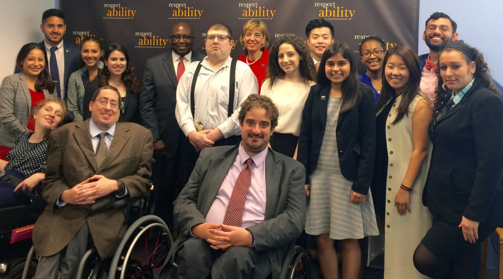 All of the fellows and staff standing in a large group against the wall with the RespectAbility logo all over it