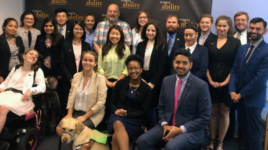 All of the fellows and staff standing in a large group against the wall with the RespectAbility logo all over it