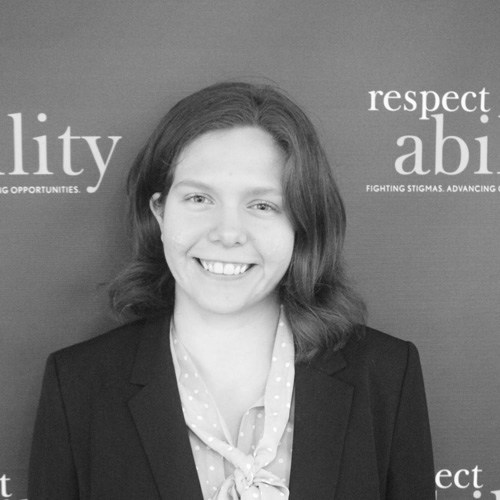 Respectability fellow Theresa Maher smiling in front of the Respectability banner