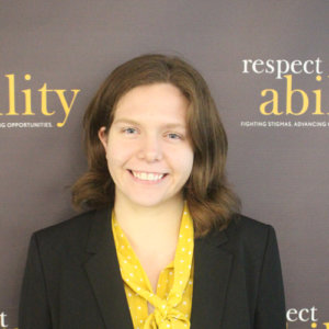 Respectability fellow Theresa Maher smiling in front of the Respectability banner