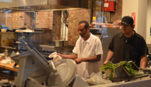 Employees working in the kitchen at Fourth and Olive