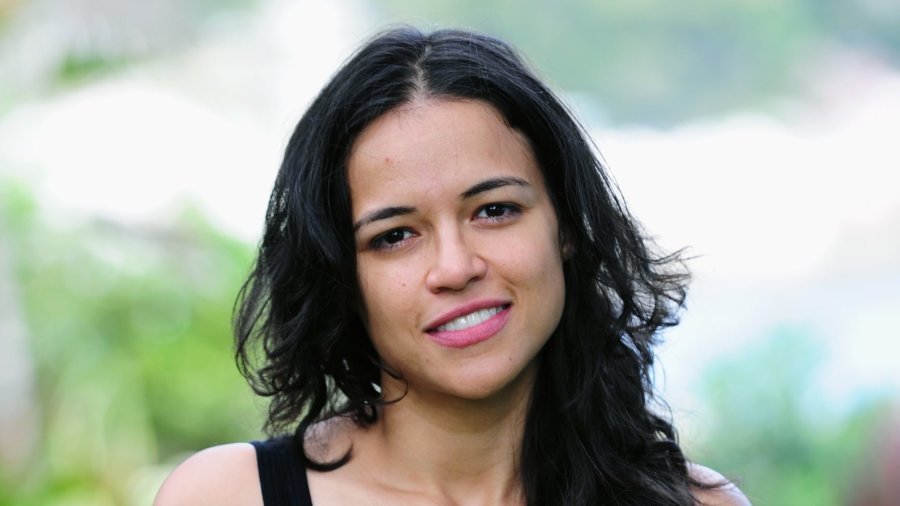 Michelle Rodriguez wearing a black tank and smiling