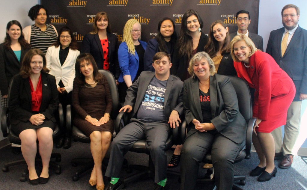 All of the fellows and staff standing in a large group against the wall with the RespectAbility logo all over it