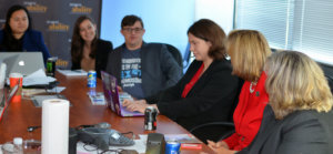 Sean and Sandra McElwee speaking to RespectAbility Fellows seated around a large brown table