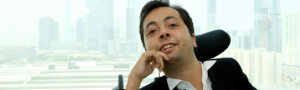 Dr. Victor Pineda with a backdrop of a city's skyline behind him