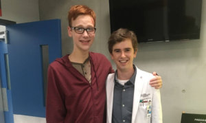 Coby Bird and Freddie Highmore standing and posing on set for the camera