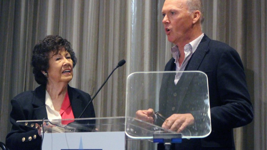 Fern Field and Michael Keaton speaking behind the podium