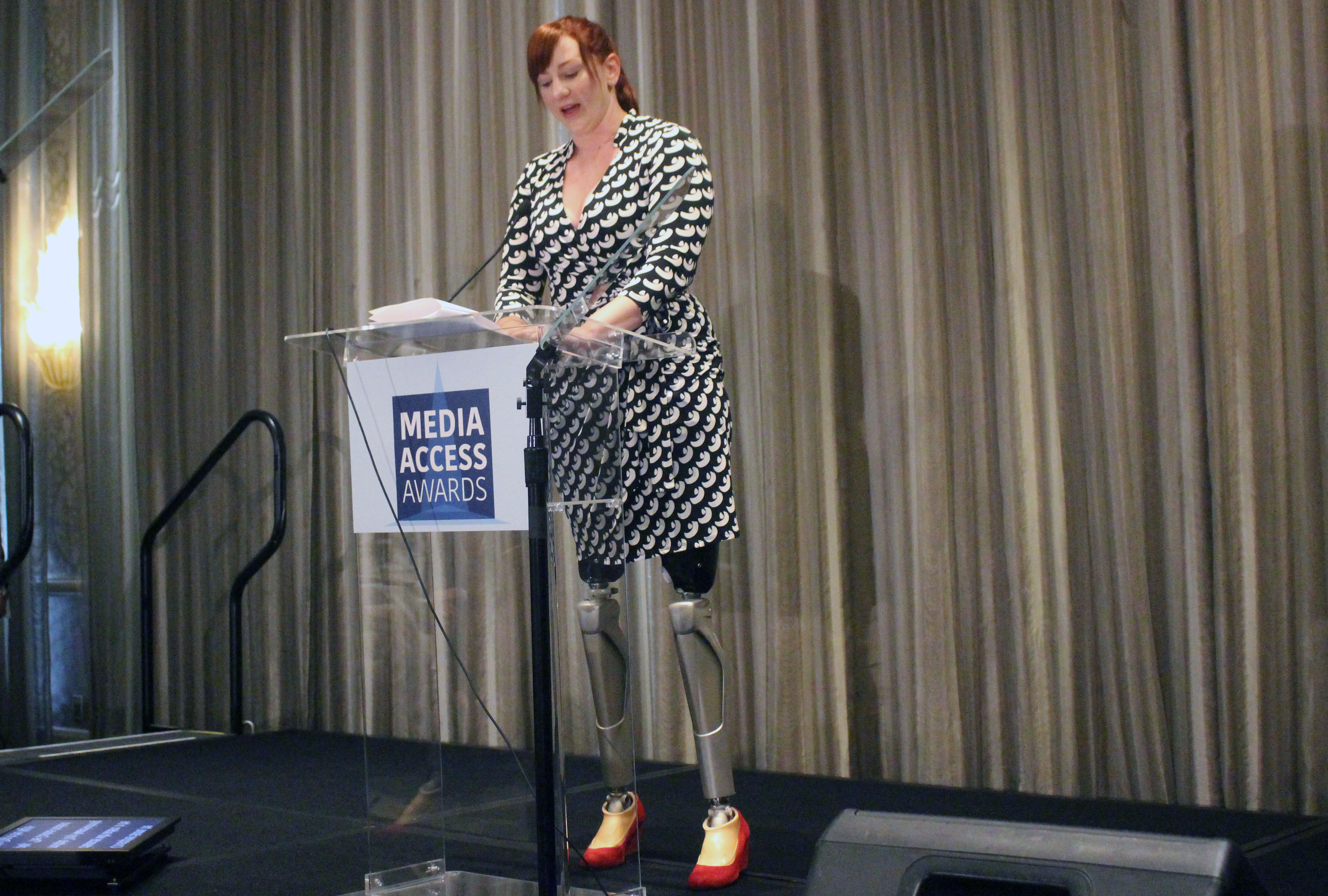 Katy Sullivan presenting the award - prosthetic legs are visible