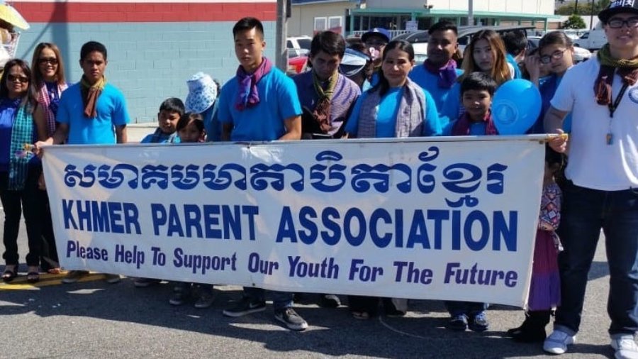 A group of people holding a banner reading 