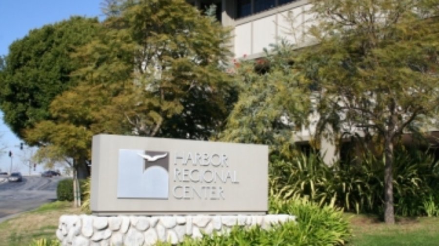 A sign outside the Harbor Regional Center with the center's logo