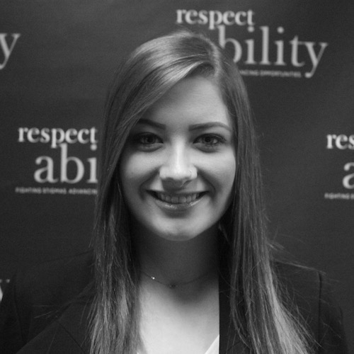 RespectAbility fellow Richelle Ross smiling in front of the RespectAbility banner