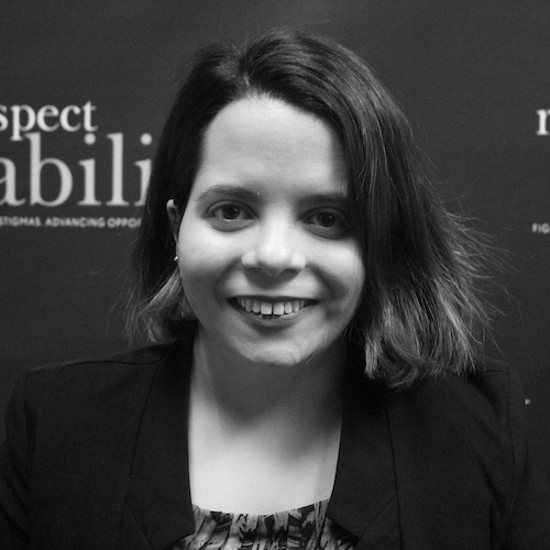 RespectAbility Policy, Practices and Latinx Outreach Associate Stephanie Farfan smiling in front of the RespectAbility banner