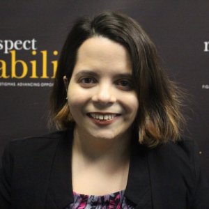 RespectAbility fellow Stephanie Farfan smiling in front of the RespectAbility banner