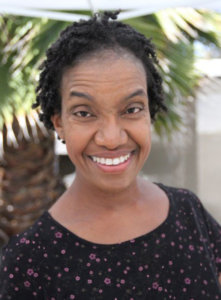 Diana Elizabeth Jordan smiling in front of a tree