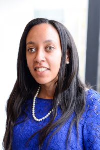 headshot of Haben Girma wearing a blue dress and pearls