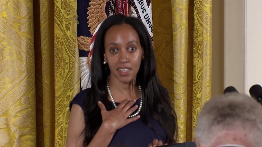 Haben Girma wearing a black dress and white pearls