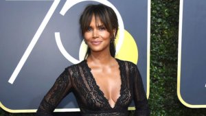 Halle Berry smiling for the camera in a black dress