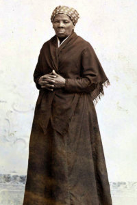 Harriet Tubman standing and posing for a picture wearing a long dress