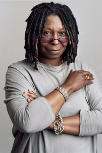 Whoopi Goldberg headshot wearing a gray sweater