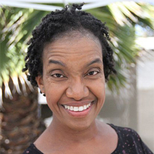 Diana Elizabeth Jordan smiling in front of a tree