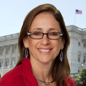 Debbie Fink smiling in front of a building