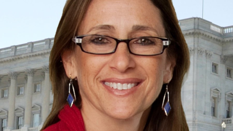 Debbie Fink smiling in front of a building