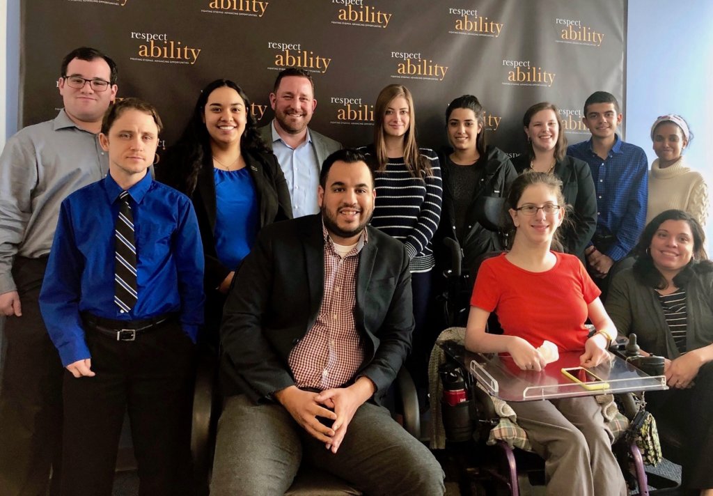 Aaron Dorfman with RespectAbility staff and Fellows in front of the RespectAbility banner