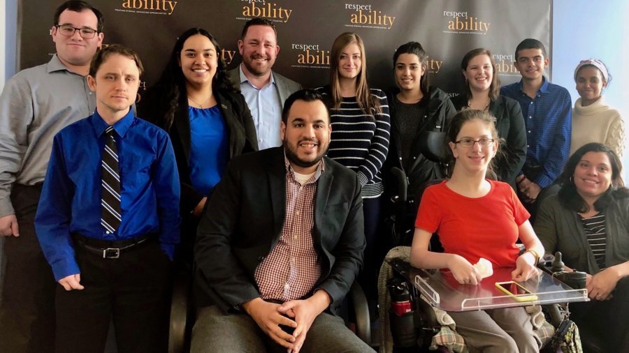 Aaron Dorfman with RespectAbility staff and Fellows in front of the RespectAbility banner