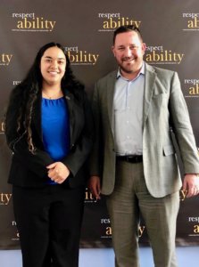 Aaron Dorfman and RespectAbility Fellow Juliet Arcila Rojas in front of the RespectAbility banner